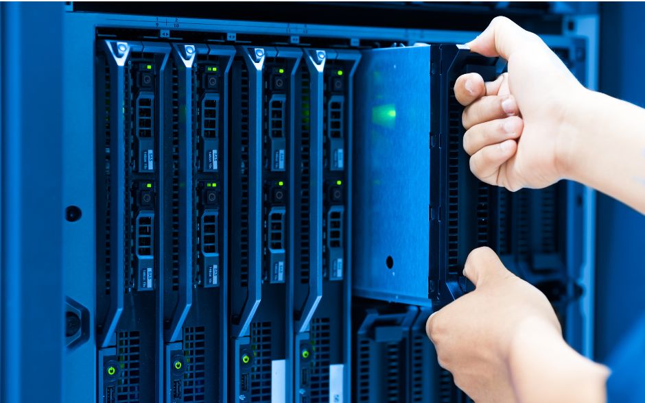 IT technician in a server room, engrossed in IT in front of data storage equipment.